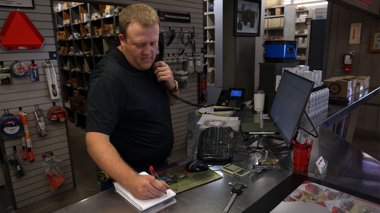 Service employee taking parts order over the phone.