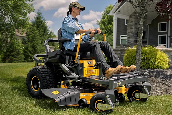 Homeowner operating a Cub Cadet zero-turn mower for smooth, controlled mowing on a residential lawn