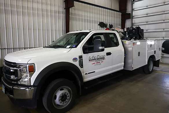 Lake Henry Implements service truck parked inside the service bay.